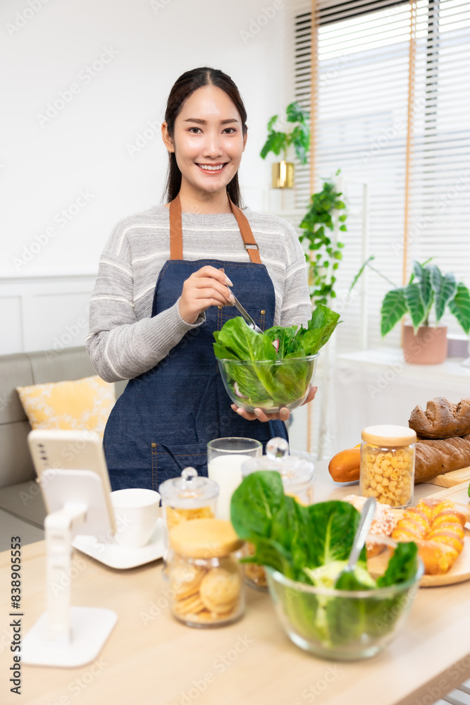 Asian woman drinking milk and eating vegetable breakfast in kitchen at home . Asian woman drinking milk and eating vegetable breakfast in kitchen at home .