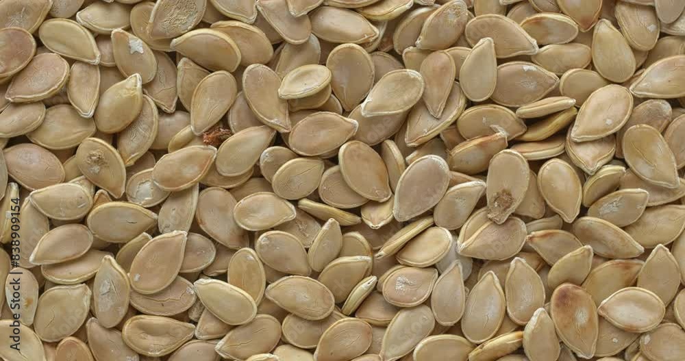 Background of Hokkaido squash unshelled seeds. Table spin. Background of Hokkaido squash unshelled seeds. Table spin.