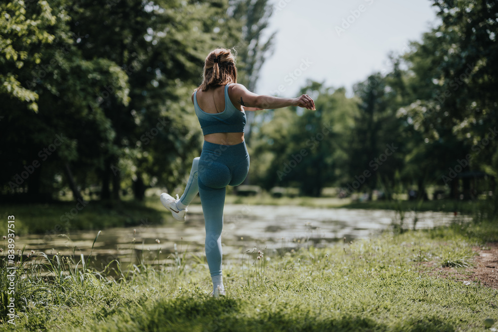 Woman practicing yoga and stretching by a pond in a sport park. Relaxation, fitness, and nature combined in a serene outdoor environment. Woman practicing yoga and stretching by a pond in a sport park. Relaxation, fitness, and nature combined in a serene outdoor environment.
