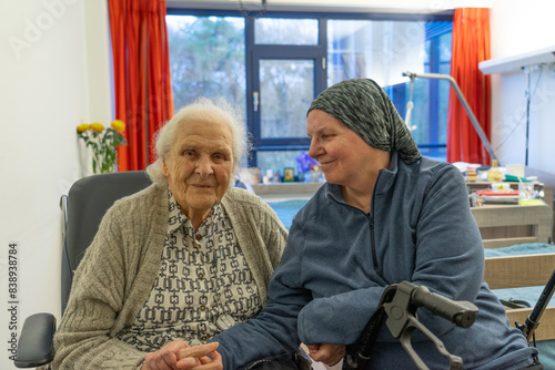 elderly woman over 90 years old with her daughter in a hospital room