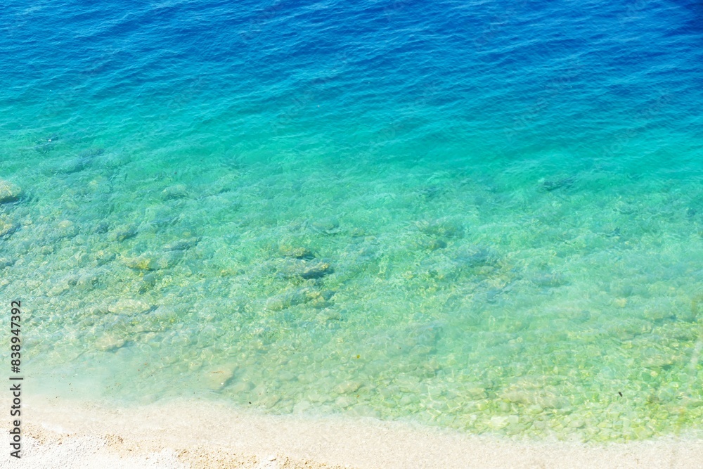 Turquise clear blue sea with sandy beach summer background Turquise clear blue sea with sandy beach summer background