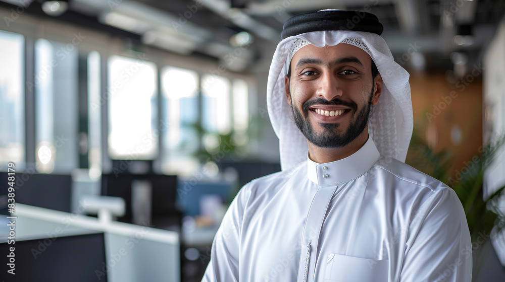 Portrait of a smiling Arabian business man in a modern office, with a black beard Portrait of a smiling Arabian business man in a modern office, with a black beard