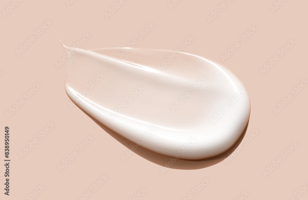 cosmetic smear of creamy texture on a beige background cosmetic smear of creamy texture on a beige background