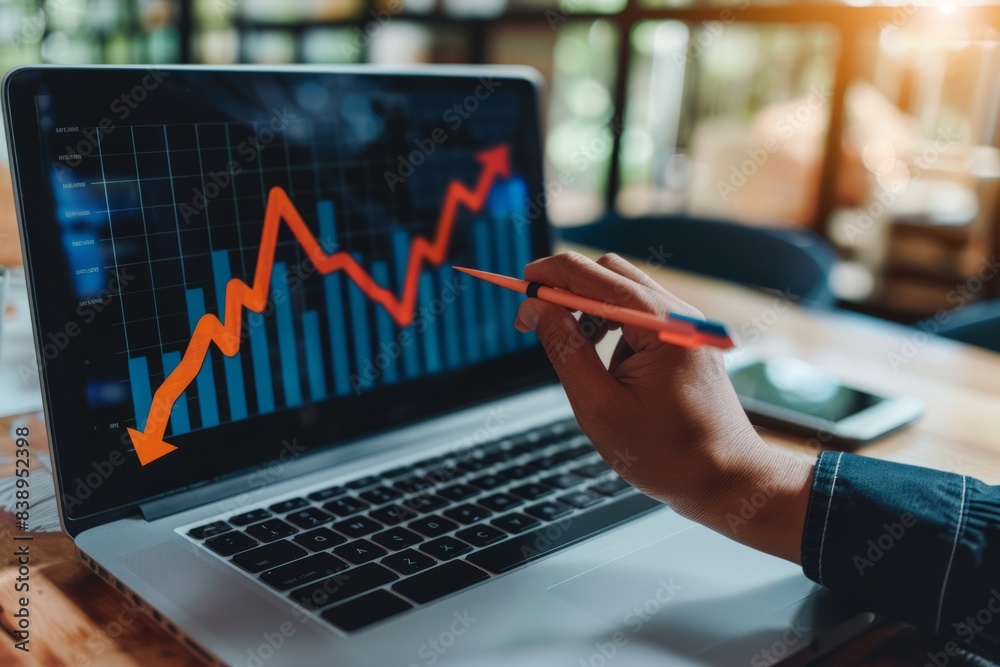 Investment strategy planning. Businessperson hands use a laptop with arrows graphically displayed on an upward growth screen, analyzing financial growth charts, and business planning. Investment strategy planning. Businessperson hands use a laptop with arrows graphically displayed on an upward growth screen, analyzing financial growth charts, and business planning.