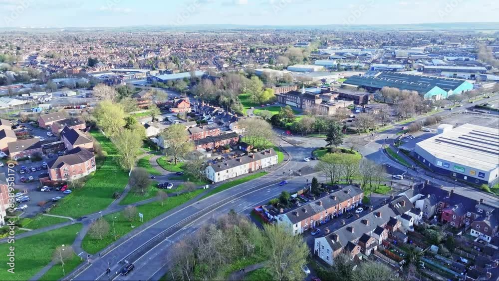 Cars are running along the lively roads in Derby, UK. The city is densely built with private homes, warehouses, shopping malls, and businesses. Cars are running along the lively roads in Derby, UK. The city is densely built with private homes, warehouses, shopping malls, and businesses.