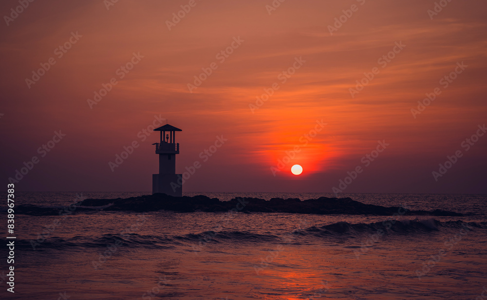 A lighthouse in the ocean during a beautiful sunset A lighthouse in the ocean during a beautiful sunset