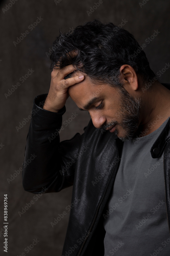 Portrait of an Indian man, holding his head Portrait of an Indian man, holding his head