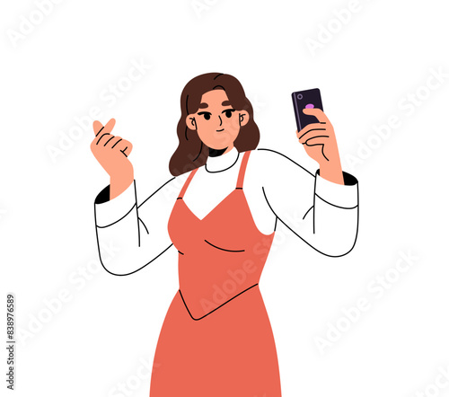 Cute girl shows Korean symbol of love with fingers for photography. Young woman hand gesturing heart sign for selfie. Happy person taking a photo by phone. Flat isolated vector illustration on white