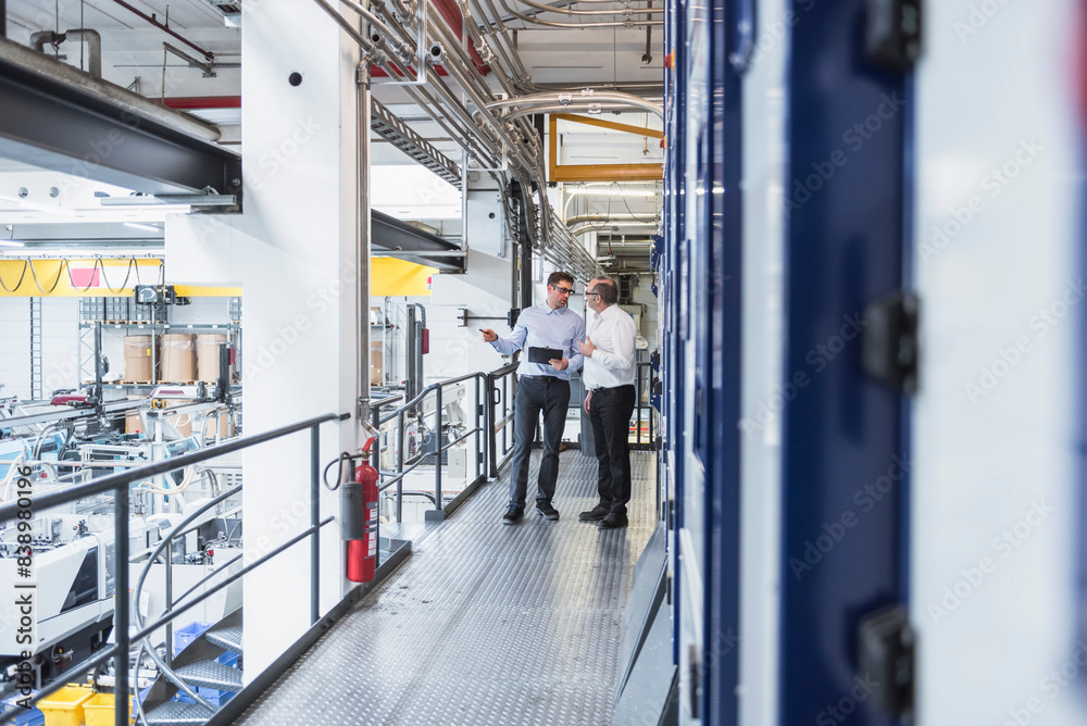 Two men talking in factory shop floor