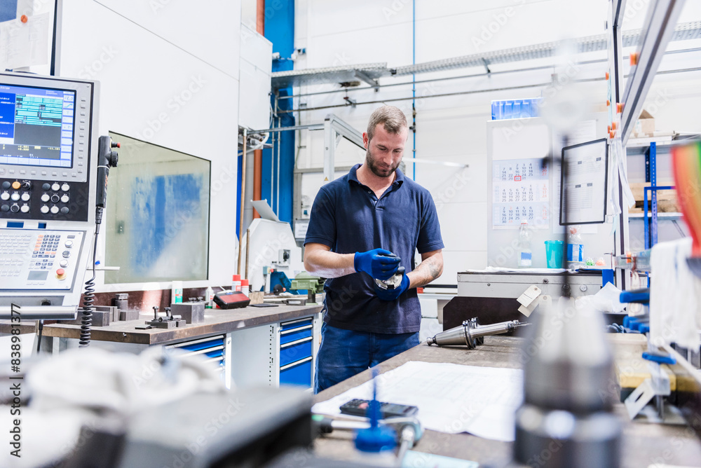 Man holding tool in industrial factory Man holding tool in industrial factory