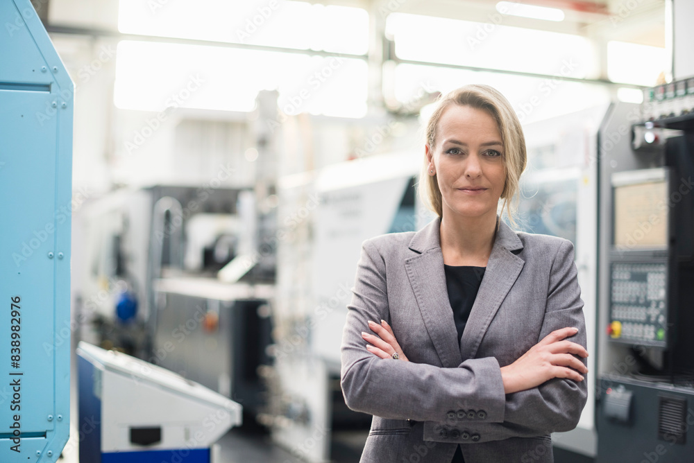 Portrait of confident woman in factory shop floor Portrait of confident woman in factory shop floor