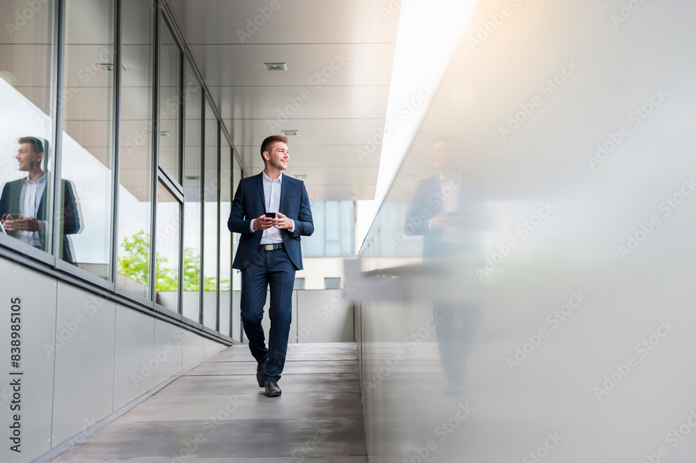 Young businessman with cell phone in the city on the