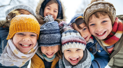 Group of children wrapped in warm winter clothes hugging outdoors on a snowy day. Low angle view capturing the joy, warmth, and friendship of kids during the winter season