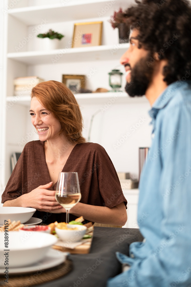 Friends having fun at a dinner party, enjoying eating together Friends having fun at a dinner party, enjoying eating together