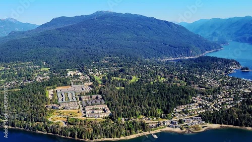 Neighbourhoods and Mountains of North Vancouver near Deep Cove on the Burrard Inlet in BC Canada - Aerial Helicopter View photo