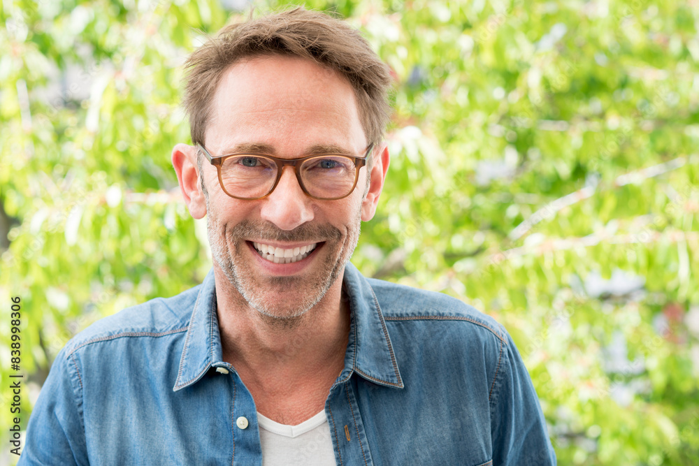 Portrait of laughing mature man with stubble wearing glasses Portrait of laughing mature man with stubble wearing glasses