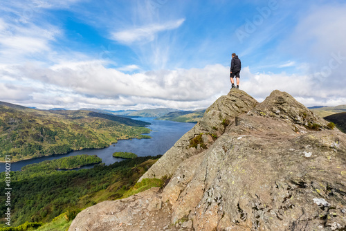 UK, Scotland, Highland, Trossachs, tourist looking from mountain Ben A'an to Loch Katrine photo
