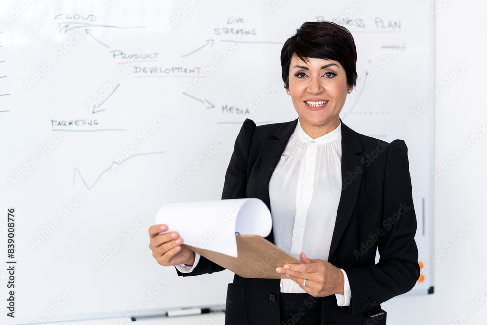 Portrait of businesswoman posing with documents in hands Portrait of businesswoman posing with documents in hands