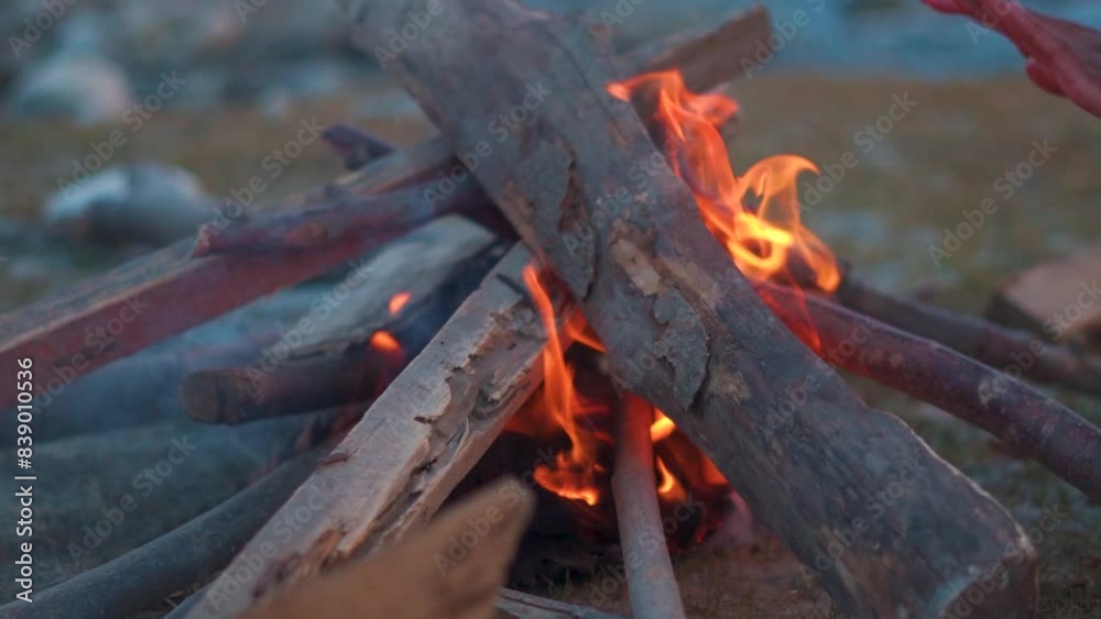 Closeup slow motion shot of bonfire made out of wood in front of river at Manali in India. Campfire in front of river to keep people warm during the cold weather. Camping in nature background Closeup slow motion shot of bonfire made out of wood in front of river at Manali in India. Campfire in front of river to keep people warm during the cold weather. Camping in nature background