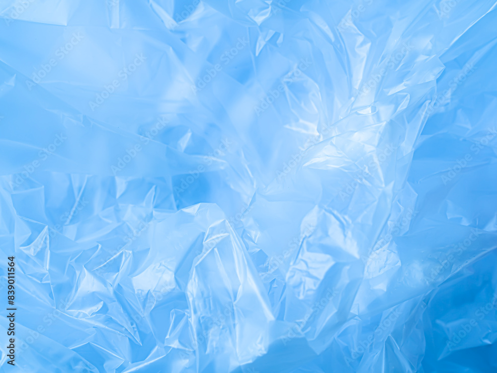 Obraz premium Blue Plastic wrinkle Bag Film Glossy Cumpled Overlay Package Background Rough Wrap Material Pack Reflection Texture Floor Packaging Retail Grain Pollution Trash, surface wrinkled Foil Polyethylene.