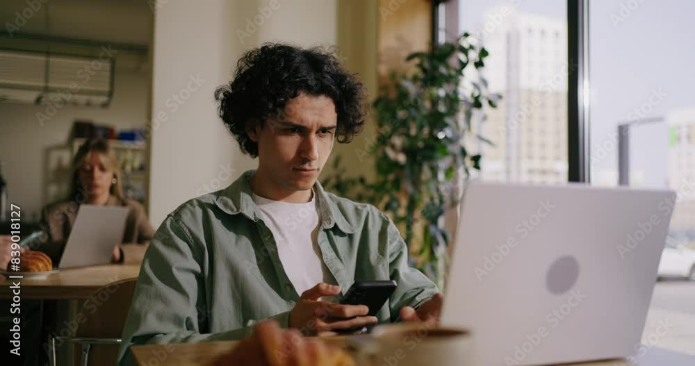 Portrait Of Hispanic Man With Smartphone Sitting In Cafe, Messaging In Mobile App, Shopping Online Portrait Of Hispanic Man With Smartphone Sitting In Cafe, Messaging In Mobile App, Shopping Online