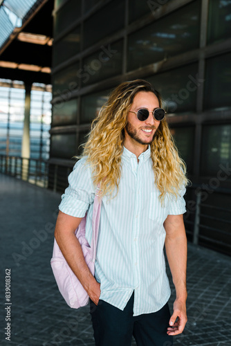 Smiling male hipster walking at railroad station © tunedin