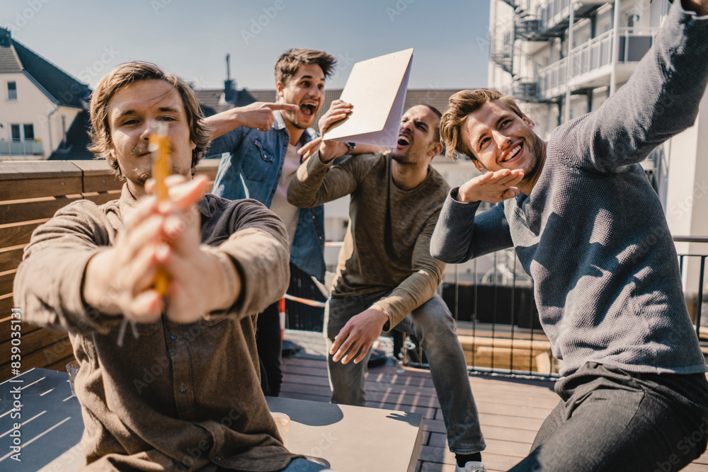 Young entrepreurs having fun on a balcony, celebrating success Young entrepreurs having fun on a balcony, celebrating success