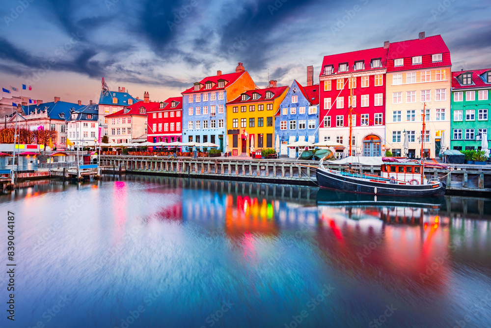 Copenhagen, Denmark. Nyhavn, Kobenhavn's iconic canal, colorful night water reflection.