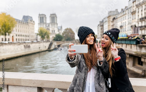 France, Paris, tourists taking selfie with cell phone photo