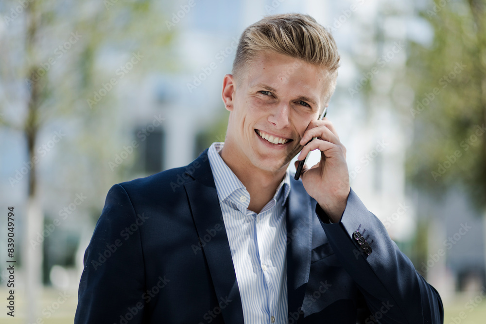 Portrait of smiling young businessman talking on cell phone Portrait of smiling young businessman talking on cell phone