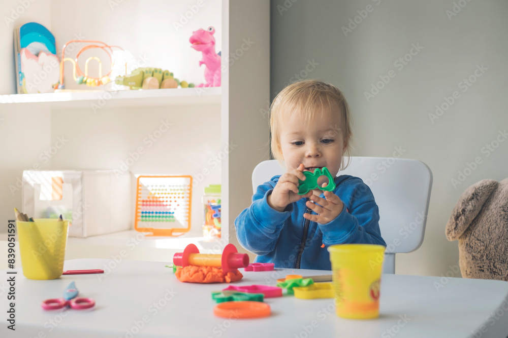 Portrait of baby girl playing with cutter and modeling clay Portrait of baby girl playing with cutter and modeling clay
