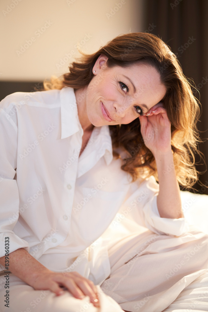 Portrait of smiling woman sitting on bed Portrait of smiling woman sitting on bed