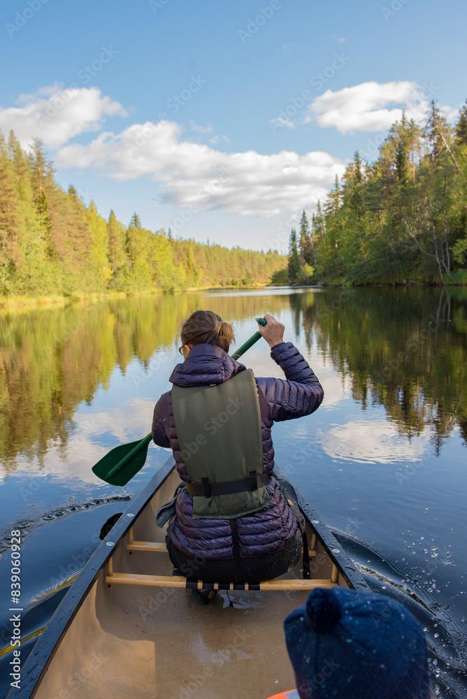 Finland, Oulanka National Park, woman in a canoe on river