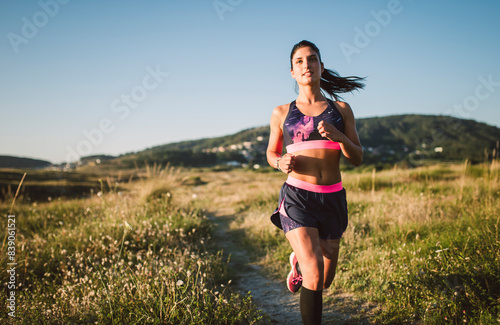 Sportswoman jogging on path © tunedin