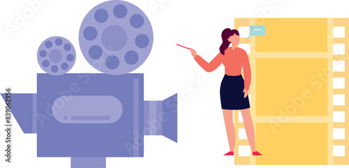 The girl is pointing at the cinema camera.