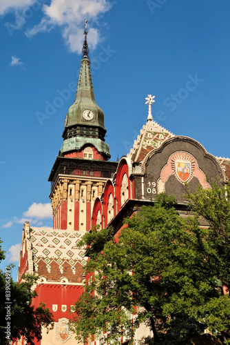 Upper facade and clock tower of the city hall, town hall on a sunny day, an example of Art Nouveau architecture in the city center of Subotica, Serbia photo