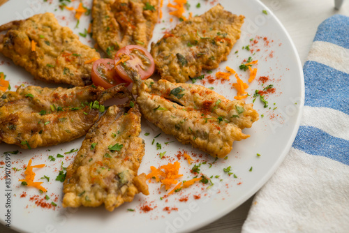 Tapa of anchovies battered with flour and egg in a Spanish restaurant. Traditional tapa of Spanish gastronomy. © Leckerstudio