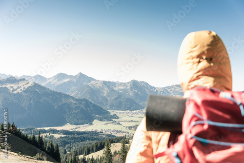 Austria, Tyrol, rear view of man on a hiking trip in the mountains enjoying the view photo