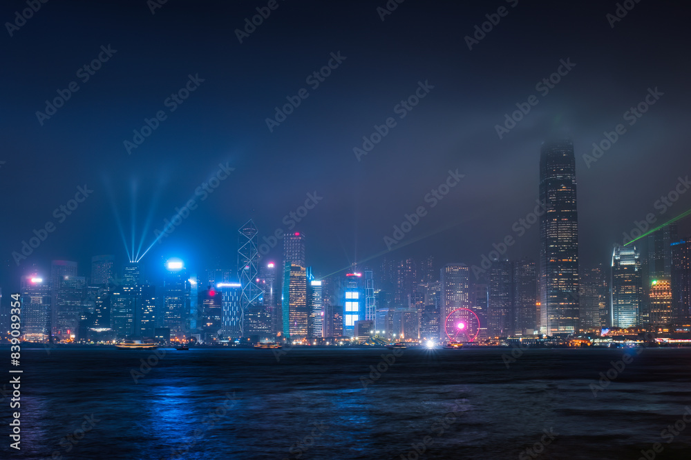 Colorful illuminated skyscraper building with laser lighting show on Victoria Harbour at Hong Kong island Colorful illuminated skyscraper building with laser lighting show on Victoria Harbour at Hong Kong island