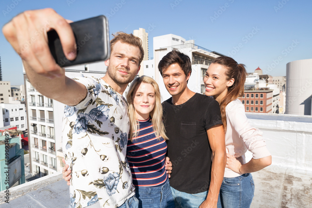 Friends taking selfies on a rooftop terrace Friends taking selfies on a rooftop terrace