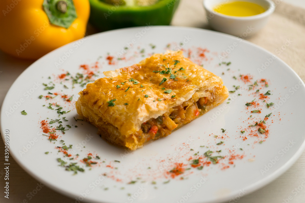 Puff pastry empanada filled with vegetables and squid. Puff pastry empanada filled with vegetables and squid.