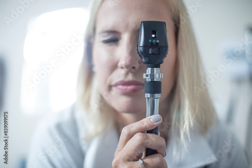 Female pedeatrician using a otoscope photo