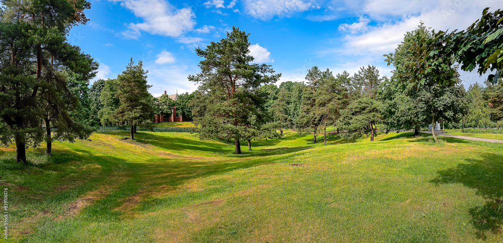 Panorama of a pine park with green trimmed lawns on a sunny day in Riga, Latvia. Clean environment concept. Panorama of a pine park with green trimmed lawns on a sunny day in Riga, Latvia. Clean environment concept.