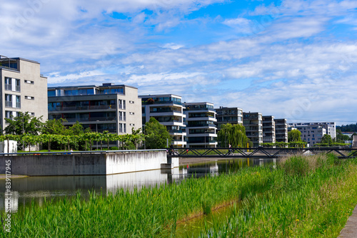 Bilde på lerret Scenic view of public park named Opfikerpark with apartment buildings and pond on a sunny spring day