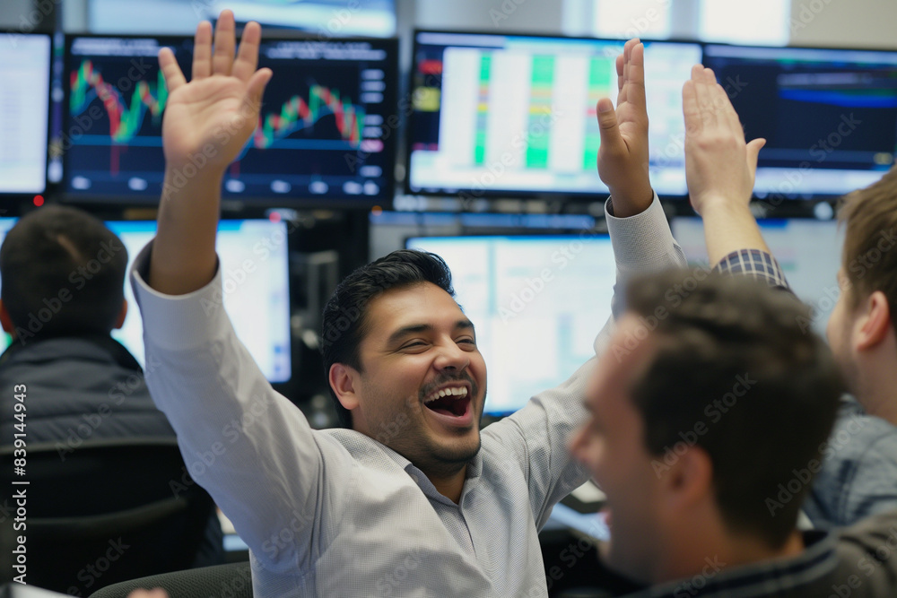 Celebrating success in trading, a group of traders in an office cheer, high-five, and smile after a successful trading day. Computer screens in the background display positive stock market results Celebrating success in trading, a group of traders in an office cheer, high-five, and smile after a successful trading day. Computer screens in the background display positive stock market results