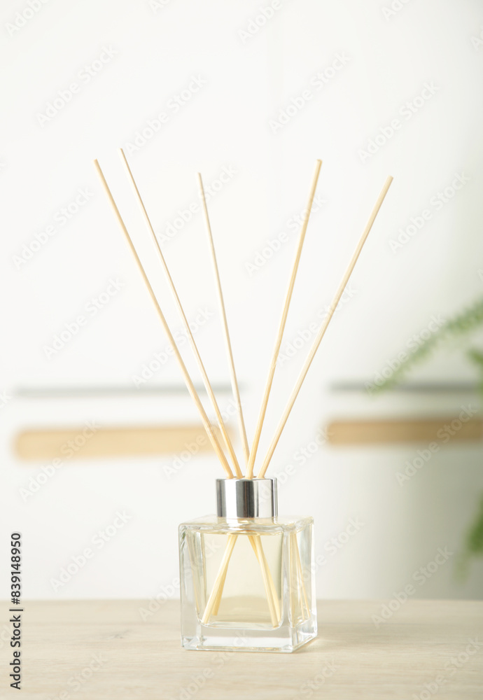 Aroma sticks in glass bottle. Aroma diffuser on table in room. Vertical photo Aroma sticks in glass bottle. Aroma diffuser on table in room. Vertical photo