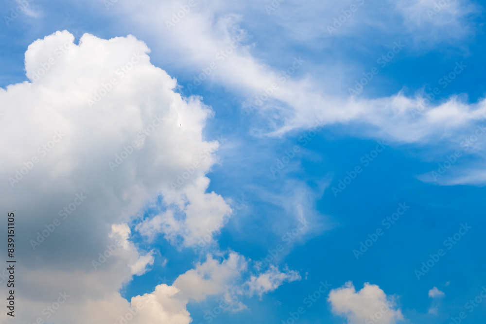 Tropical summer blue sky fluffy white cloud summertime on light sunny day cloudscape. Clear bright blue skyline spring sunlight climate background. Heaven blue environment ecology high scenic nature. Tropical summer blue sky fluffy white cloud summertime on light sunny day cloudscape. Clear bright blue skyline spring sunlight climate background. Heaven blue environment ecology high scenic nature.