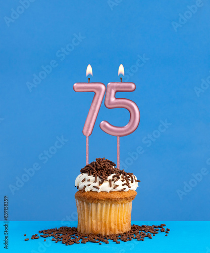 Candle number 75 - Birthday card with cupcake on blue background photo