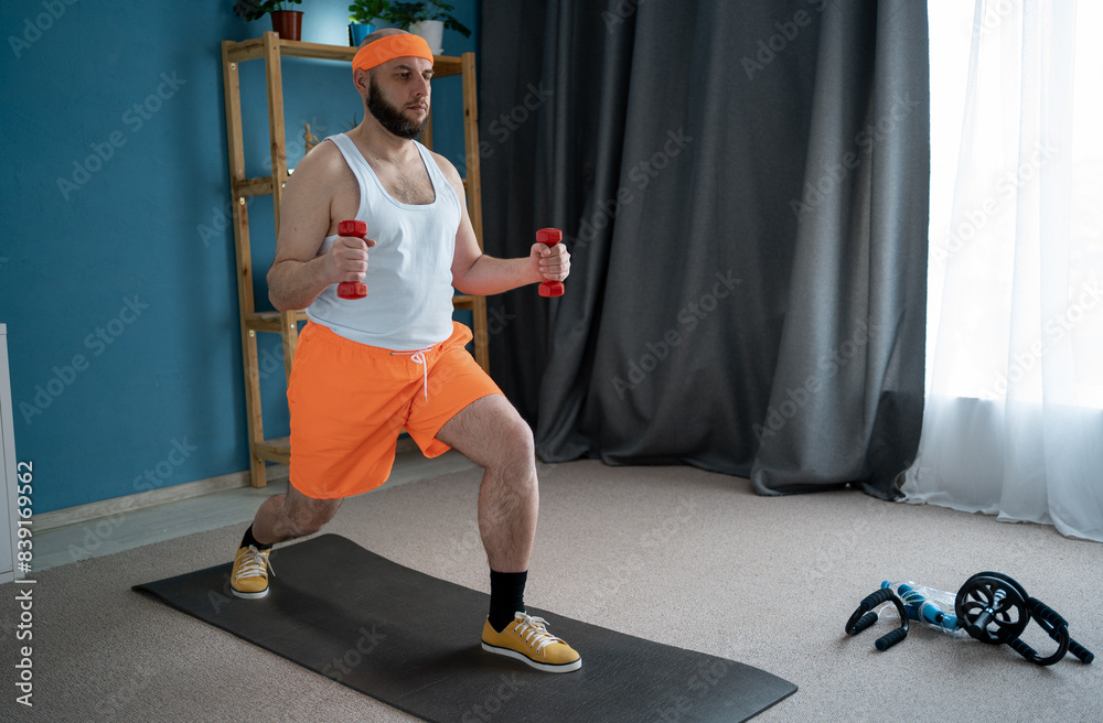 Handsome man doing lunges with light dumbbells in hands when working out at home Handsome man doing lunges with light dumbbells in hands when working out at home