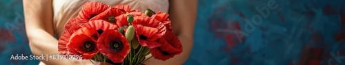 Vivid red poppies held in tender woman hands